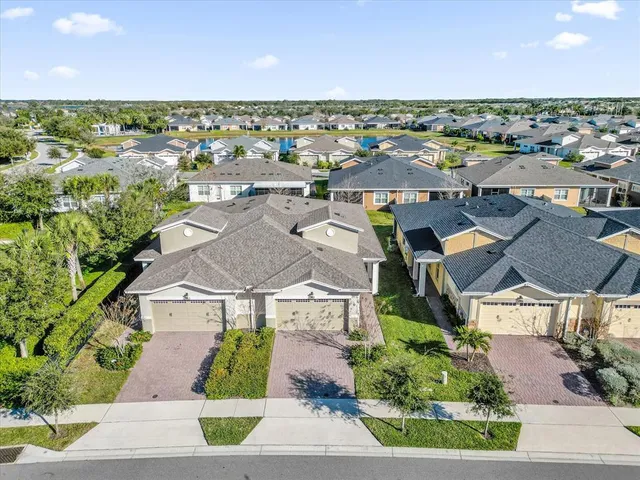 an aerial view of a house with swimming pool and ocean view