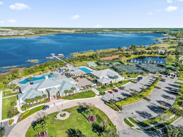 an aerial view of a tennis ground and a cars park