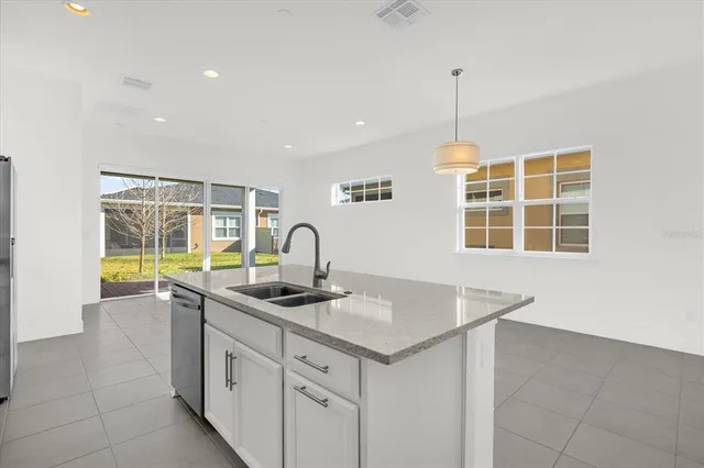 a kitchen that has a sink a stove and a window
