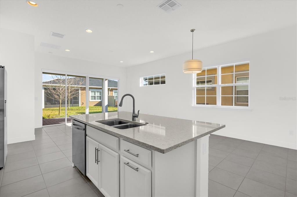 2360 Datura Loop St. Cloud, FL 34772 - Photo 7 of 46 a kitchen that has a sink a stove and a window