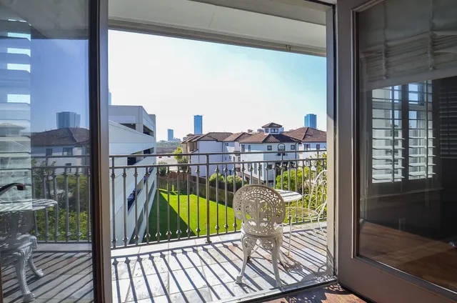 a view from a balcony with a floor to ceiling window in an outdoor view