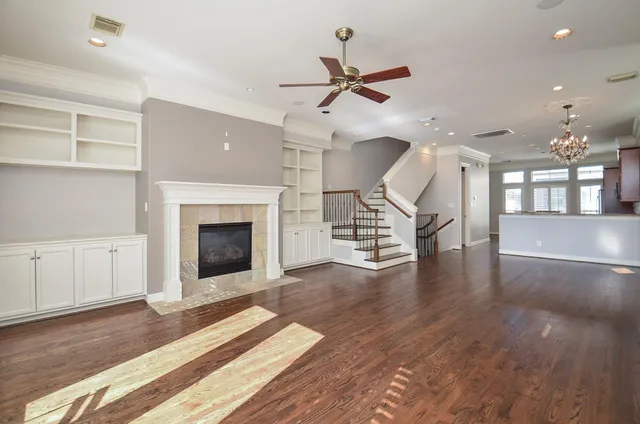 a view of a livingroom with a fireplace and wooden floor