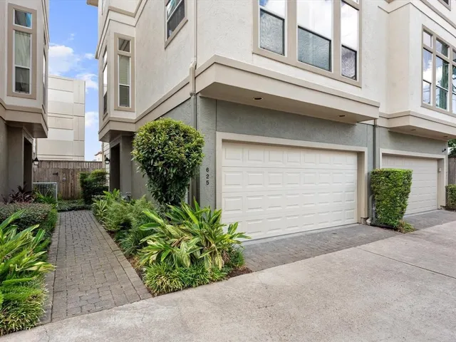 a view of a house with potted plants