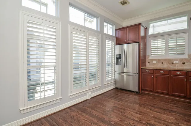 a kitchen with stainless steel appliances a refrigerator and wooden cabinets
