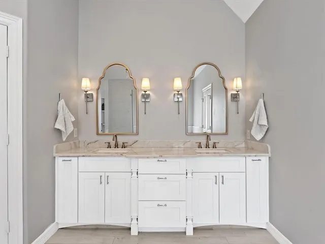 a bathroom with a double vanity sink and a mirror