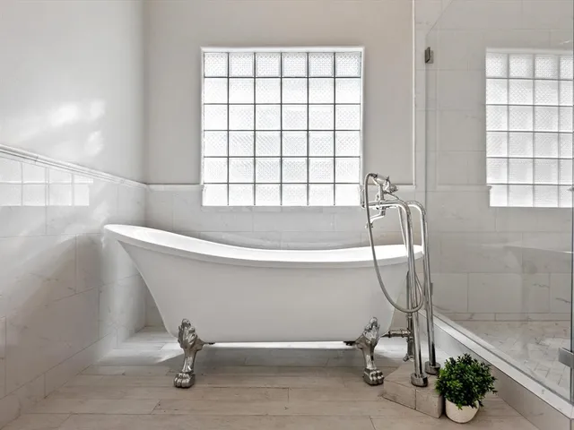 a bathroom with a bathtub and a shower