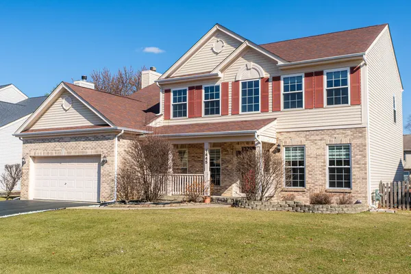 a open kitchen with stainless steel appliances granite countertop a refrigerator a sink dishwasher a stove and a dining table with wooden floor