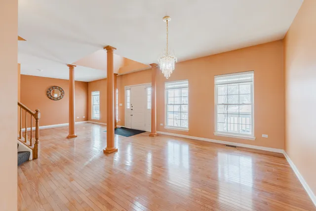 a view of an empty room with a fireplace and a window