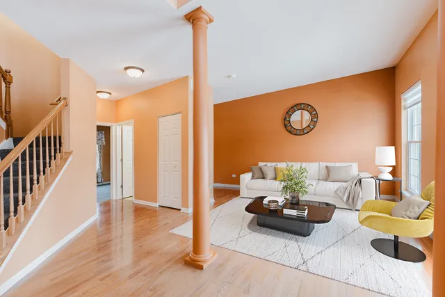 a view of a hallway with wooden floor and staircase