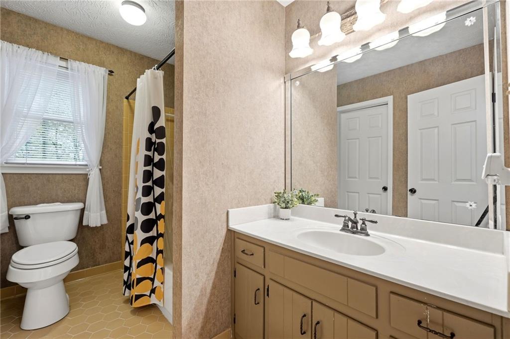 3121 Bonds Lake Road Northwest Conyers, GA 30012 - Photo 18 of 36 a bathroom with a sink a toilet and a mirror