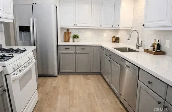 a kitchen with a sink stove and refrigerator