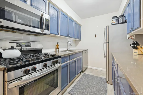 a kitchen with stainless steel appliances granite countertop a stove and a refrigerator