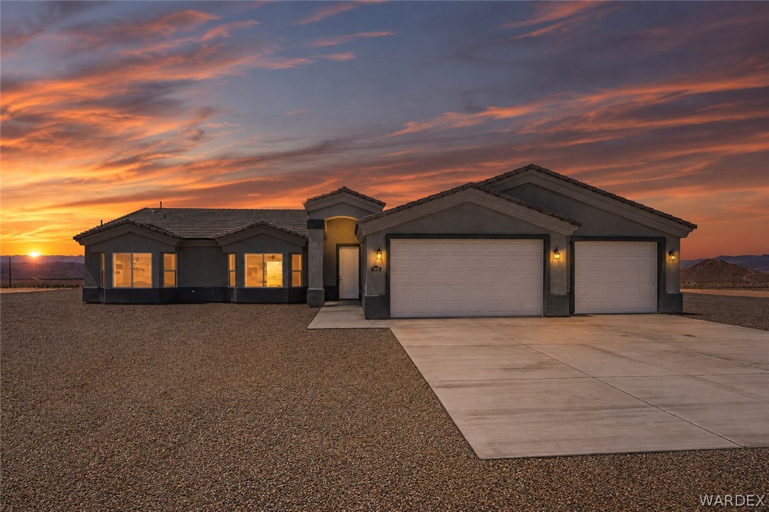 9818 North Cyrus Road Kingman, AZ 86401 - Photo 1 of 42 a front view of a house with yard and parking
