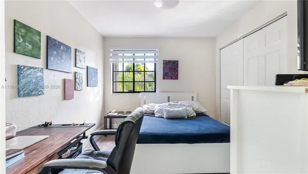 a bedroom with furniture and a window