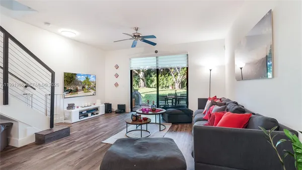 a living room with furniture and a large window