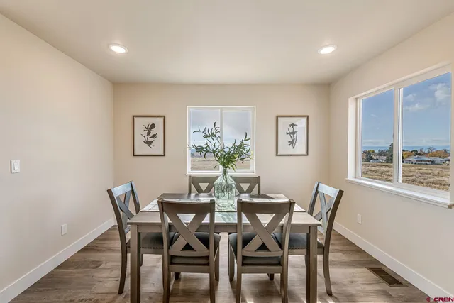 a view of a dining room with furniture and a potted plant