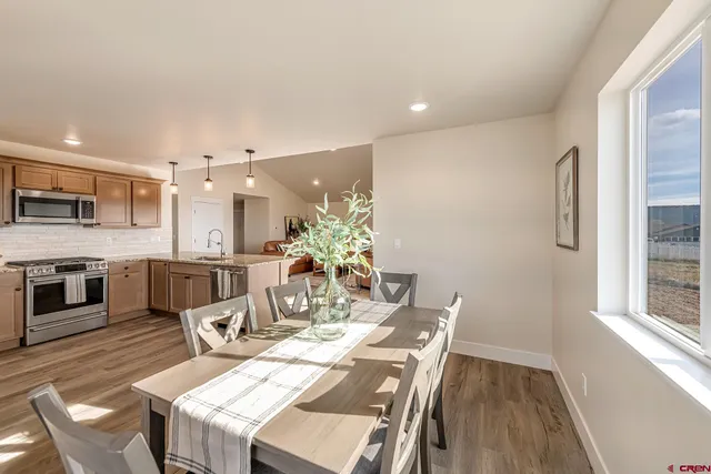 a view of a dining room with furniture and wooden floor