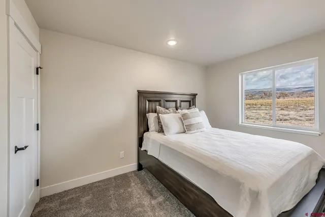 a bedroom with a bed and window