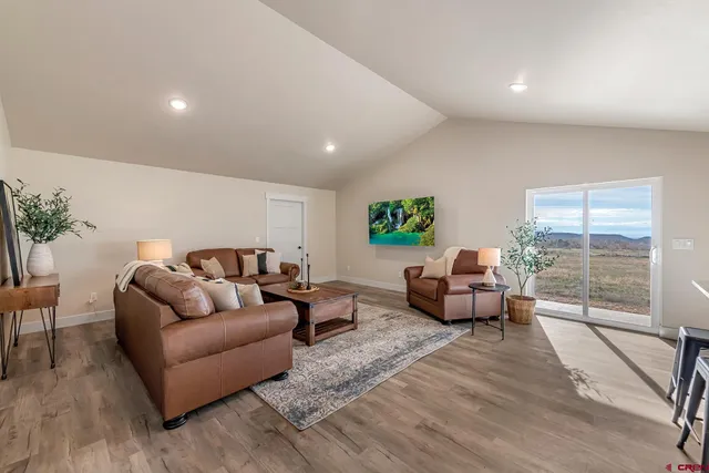a living room with furniture and a floor to ceiling window
