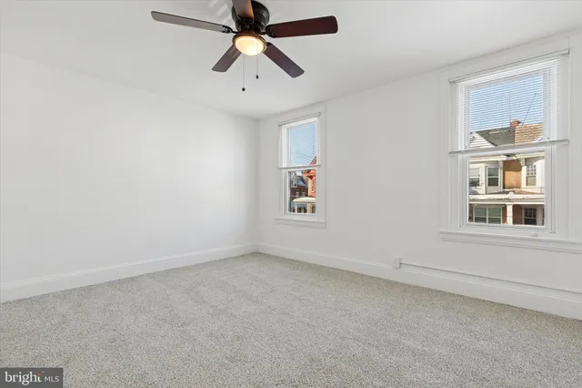 a view of water heater room with refrigerator