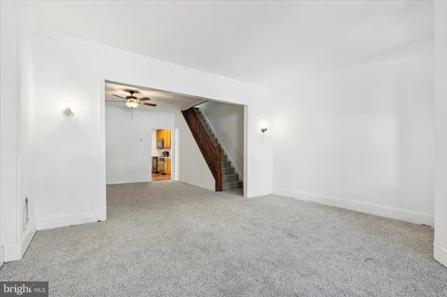 an empty room with a window and stairs