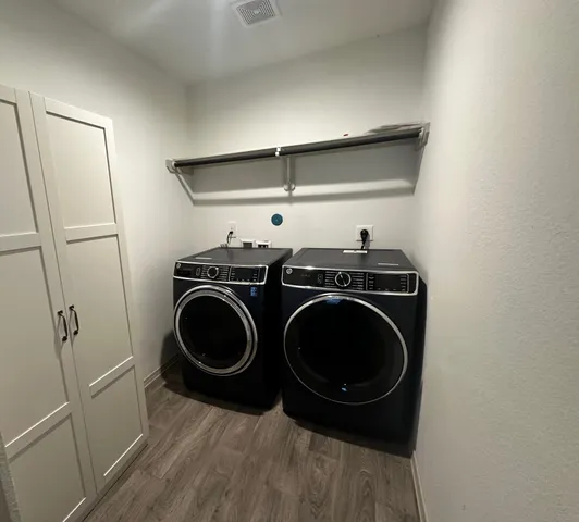 a utility room with sink dryer and washer