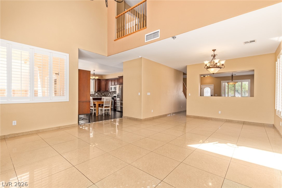 1477 Rancho Ridge Drive Henderson, NV 89012 - Photo 10 of 46 A spacious, open concept living area showcases polished tile flooring and high ceilings.