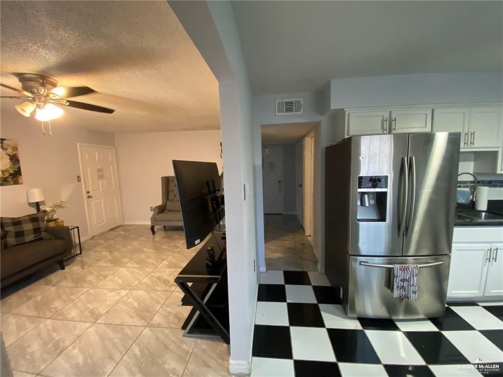 712 Toronto Avenue, Unit 6 McAllen, TX 78503 - Photo 4 of 10 a kitchen with a refrigerator a sink and cabinets