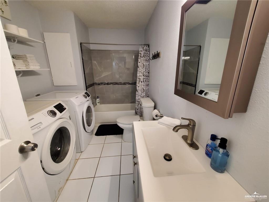 712 Toronto Avenue, Unit 6 McAllen, TX 78503 - Photo 10 of 10 a bathroom with a sink mirror and vanity
