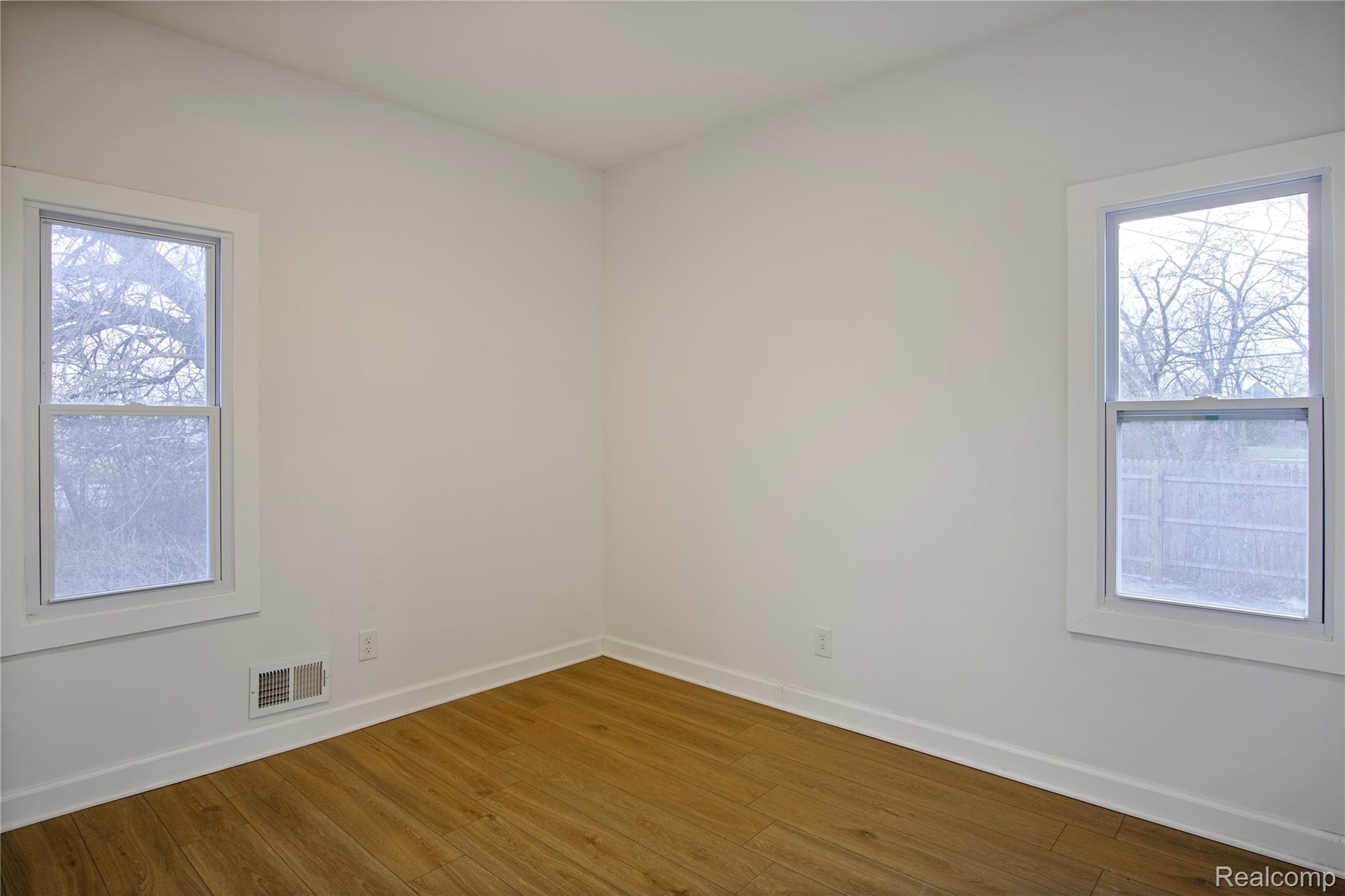 6123 Commonwealth Street Detroit, MI 48208 - Photo 9 of 14 Unfurnished room featuring wood finished floors and baseboards