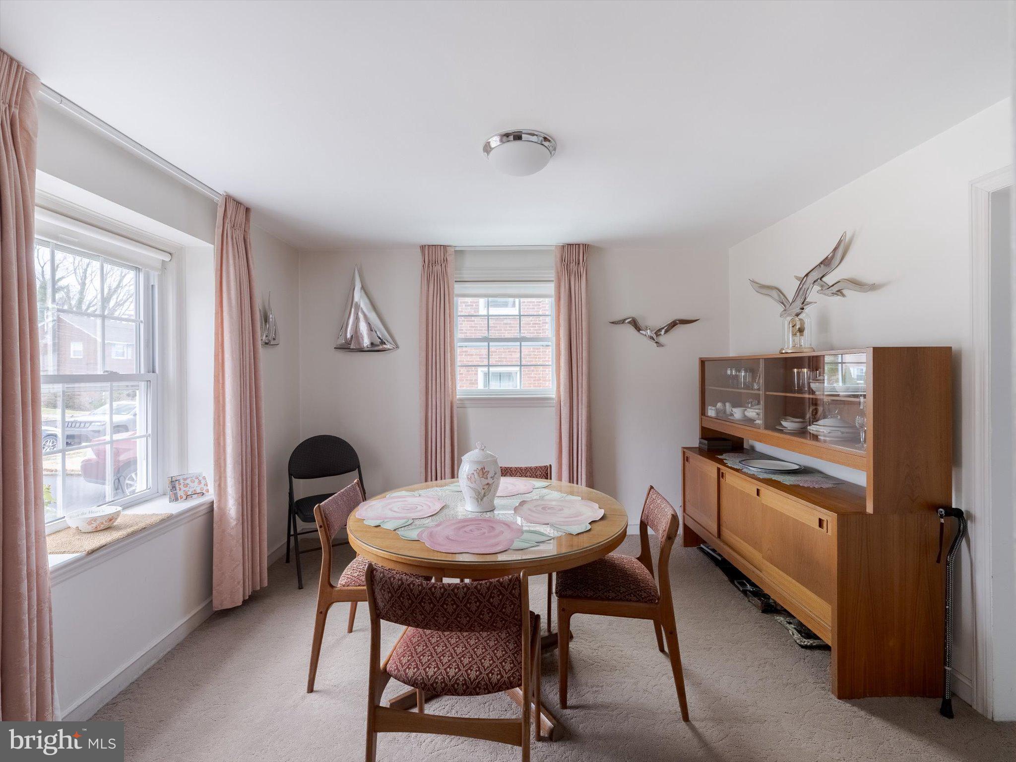 34 Schuyler Road Springfield, PA 19064 - Photo 15 of 30 a kitchen with stainless steel appliances granite countertop a dining table chairs and a refrigerator
