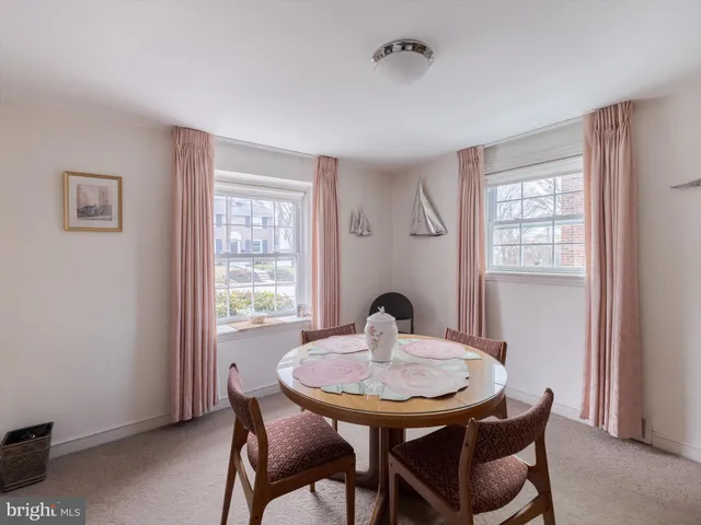 a view of a dining room with a table and chairs