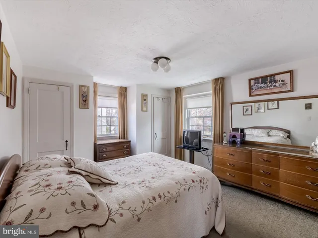 a bedroom with bed and window