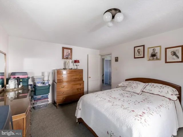 a bedroom with bed and cabinets