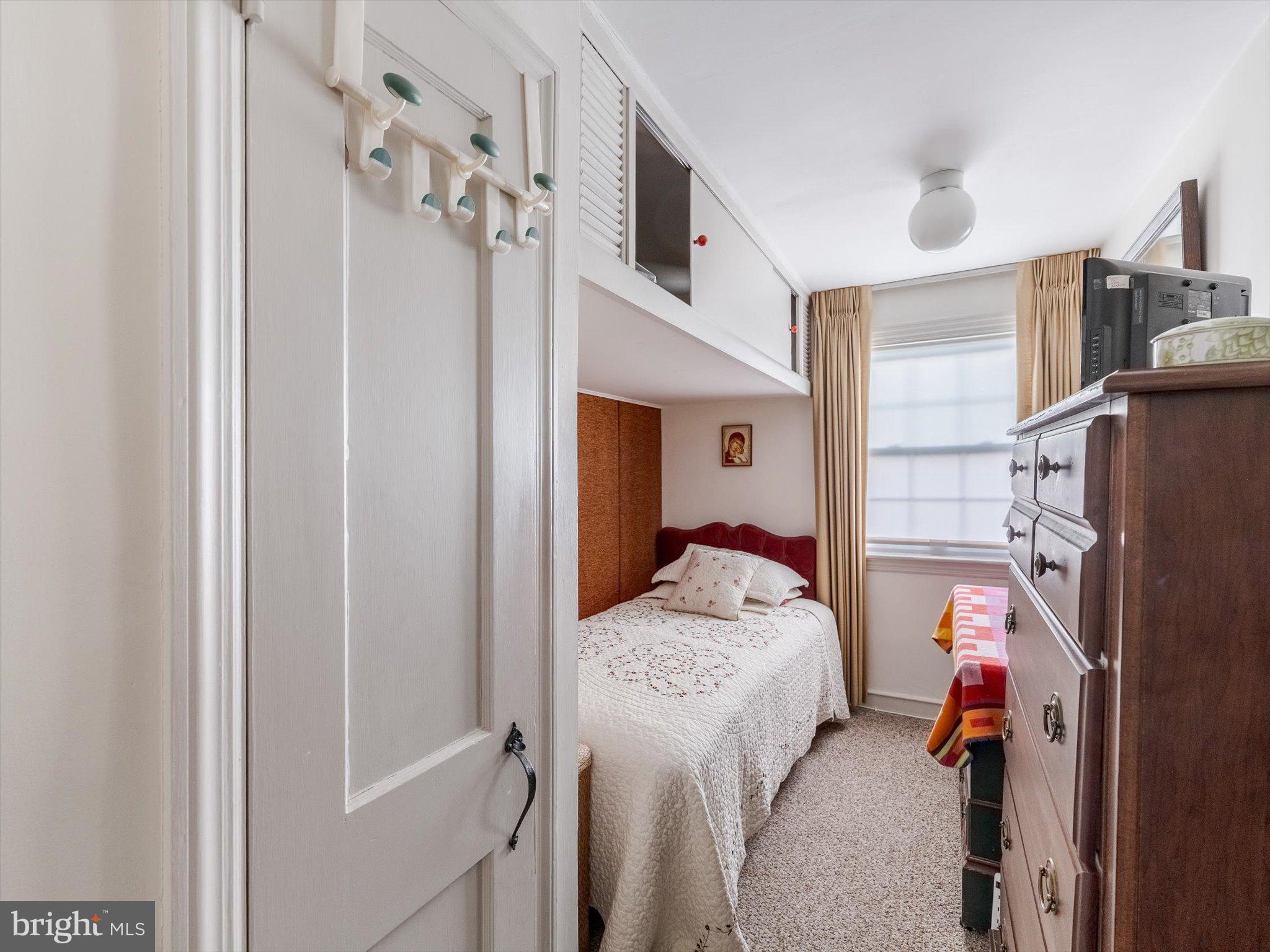 34 Schuyler Road Springfield, PA 19064 - Photo 24 of 30 a bedroom with a bed and a chandelier