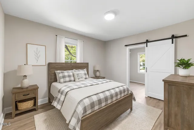 a bedroom with a bed and a potted plant