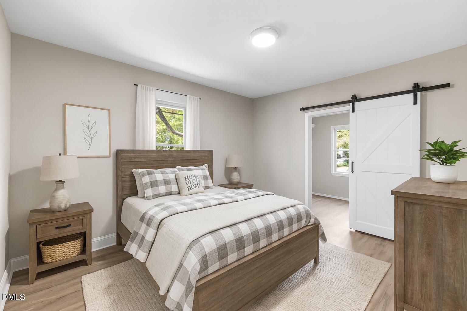 411 West I Street Erwin, NC 28339 - Photo 13 of 28 a bedroom with a bed and a potted plant