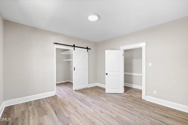 a view of an empty room and wooden floor