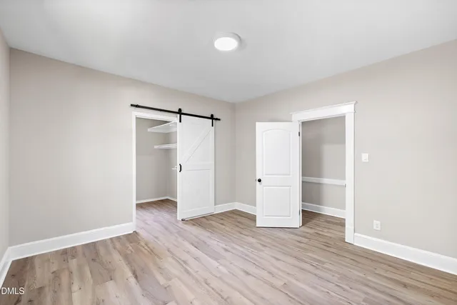 a view of an empty room and wooden floor