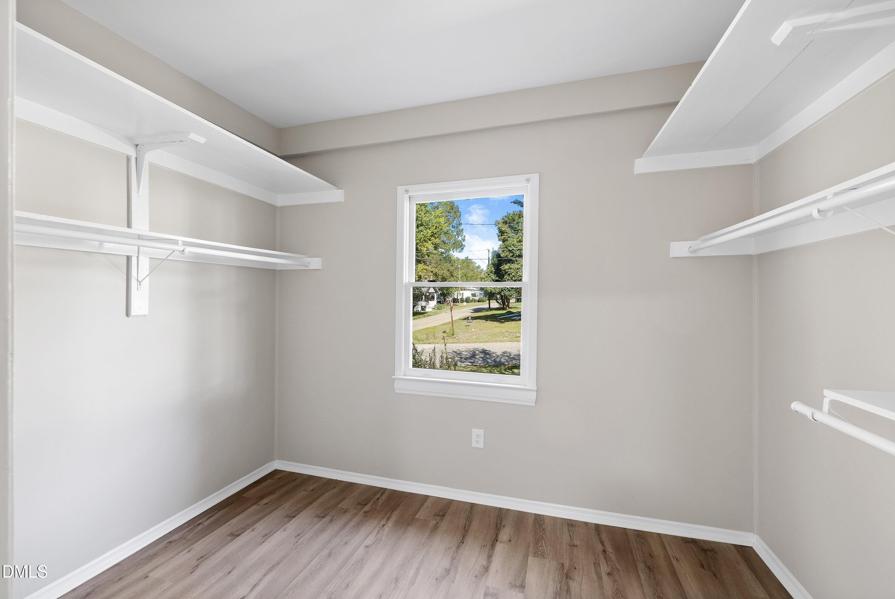 411 West I Street Erwin, NC 28339 - Photo 16 of 28 a view of a room with wooden floor closet and windows