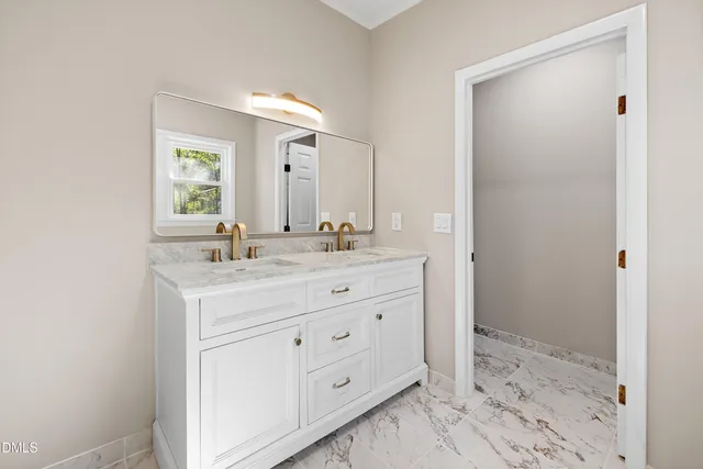 a bathroom with a shower sink and mirror