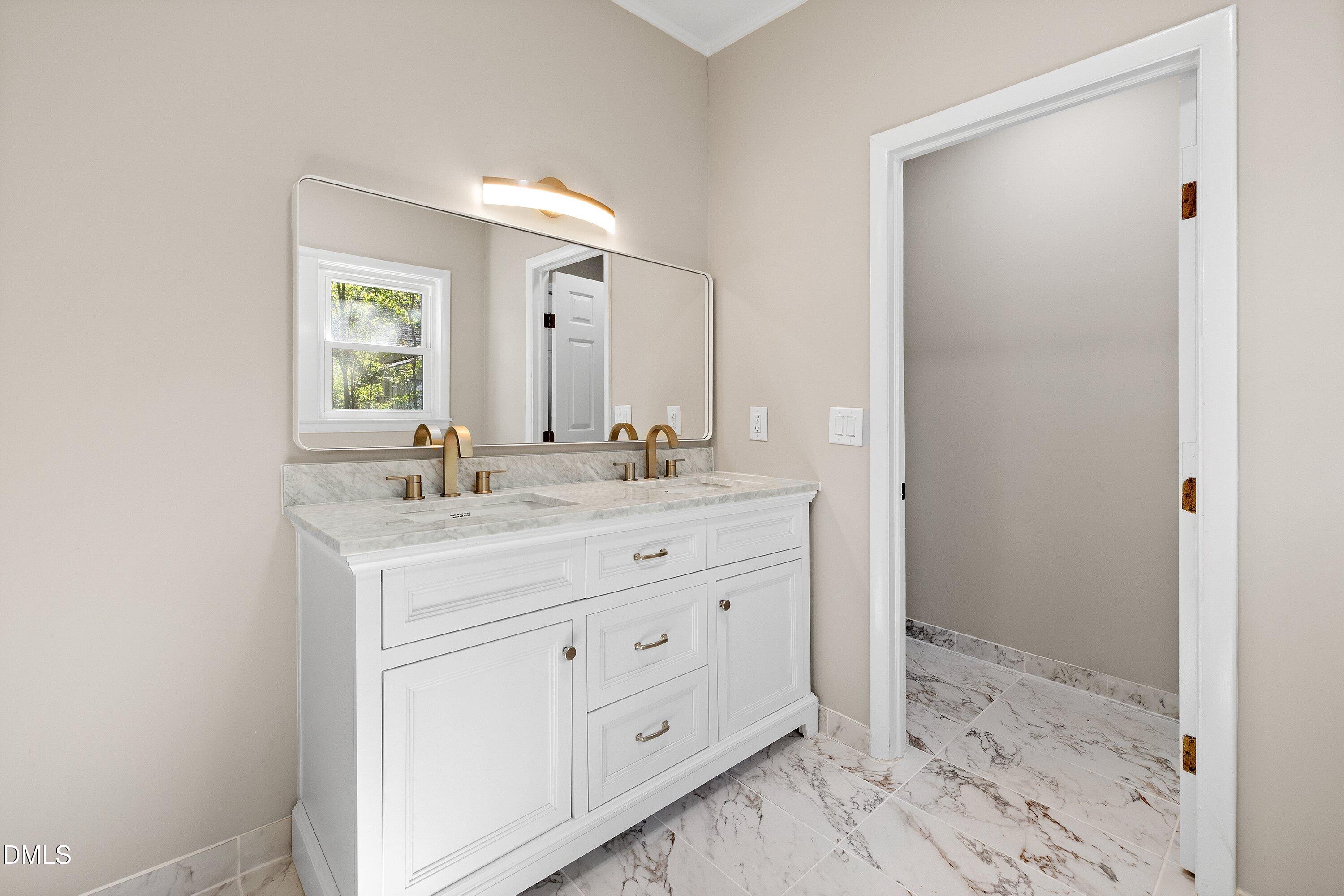 411 West I Street Erwin, NC 28339 - Photo 18 of 28 a bathroom with a shower sink and mirror