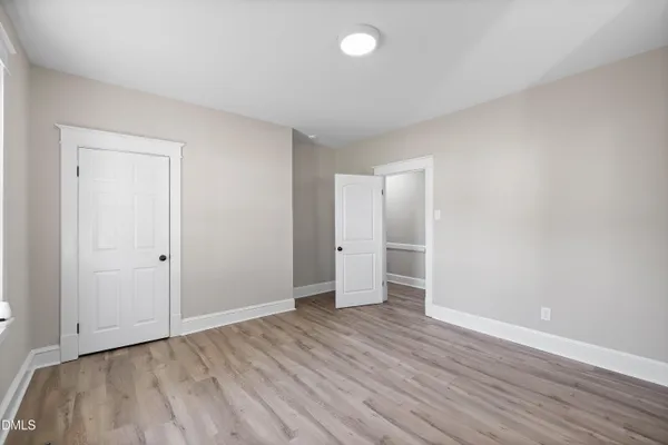 a view of an empty room and wooden floor