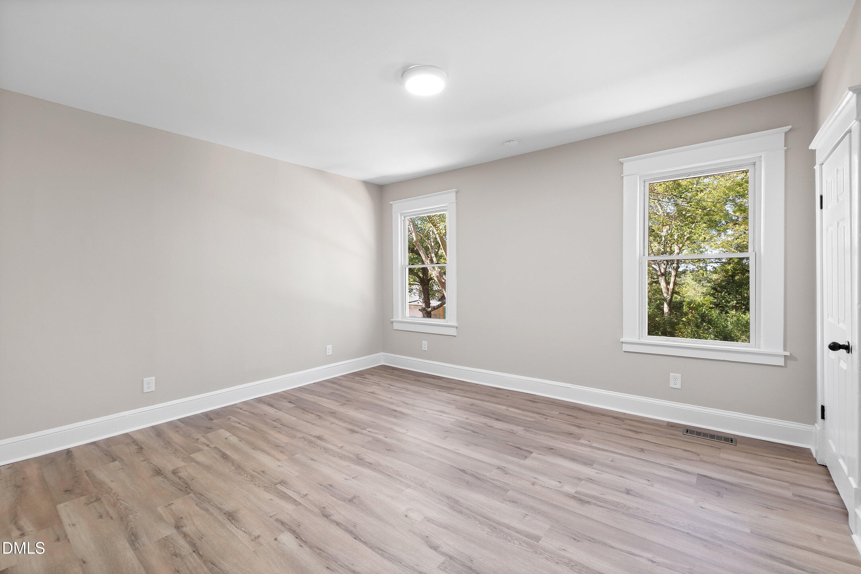 411 West I Street Erwin, NC 28339 - Photo 24 of 28 an empty room with wooden floor and windows