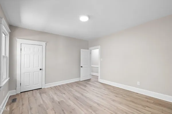 a view of an empty room and wooden floor