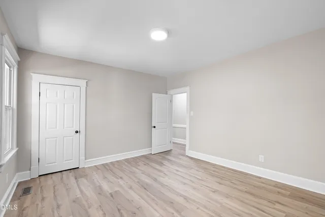 a view of an empty room and wooden floor