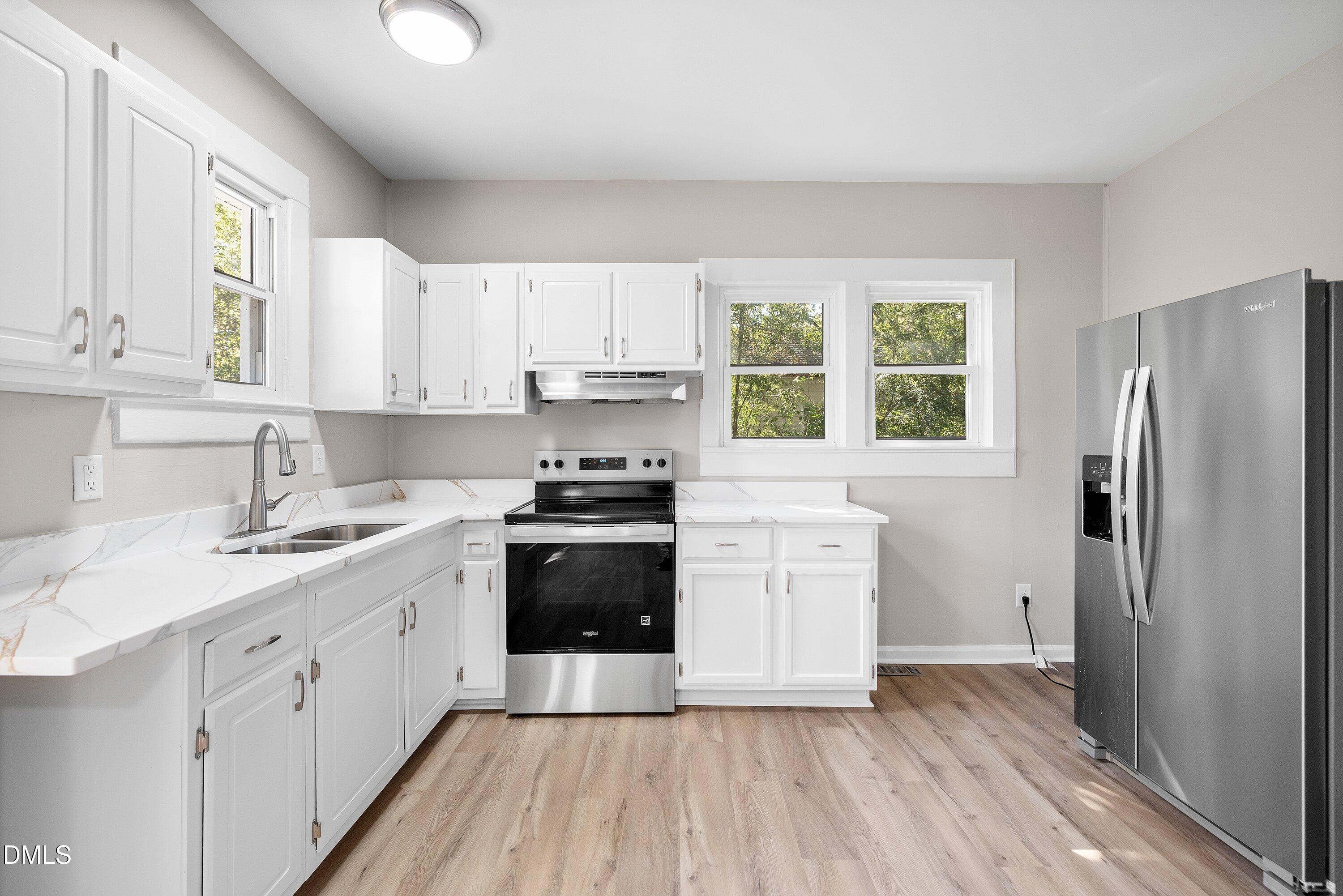 411 West I Street Erwin, NC 28339 - Photo 10 of 28 a kitchen with a refrigerator stove and sink
