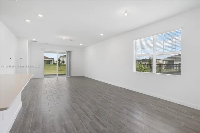 a view of kitchen with cabinets stainless steel appliances with wooden floor