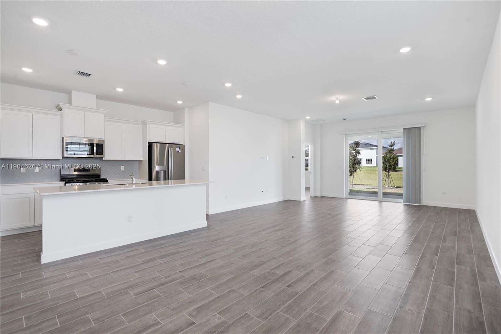 19655 Barn Swallow Way, Unit 19655 West Palm Beach, FL 33470 - Photo 12 of 59 a view of kitchen with cabinets stainless steel appliances with wooden floor