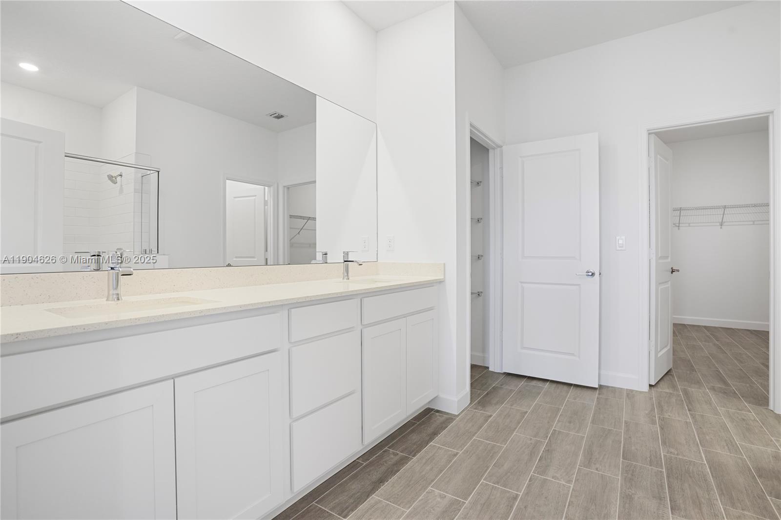 19655 Barn Swallow Way, Unit 19655 West Palm Beach, FL 33470 - Photo 18 of 59 a bathroom with a double vanity sink and mirror